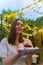 Birthday party. A young woman with cake and one candle in illuminated patio. Happy Holiday