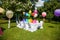 Birthday table with rainbow balloons. Summer holiday in the park