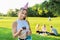 Birthday, teenage girl in festiv hat with cake and candle at outdoor party