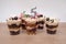 Birthday trifle cake with candle labeled number 5. five portioned mini cakes