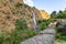 Birthi waterfall surrounded by mountain landscape with view of local shepherd at Munsiyari Uttarakhand India