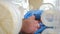 Birthing home and Kid health concept. Closeup shot of nurse hands in blue gloves touching newborn baby head, feet and