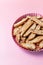 Biscotti with nuts on pink background. Delicious cantucci cookies. Cantuccini. Traditional italian homemade biscuits.