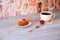 A biscuit cake saucer and a cup of black coffee with cinnamon and anise on a napkin