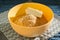 Biscuit crumbs and butter in yellow bowl close up