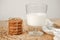 Biscuit with a glass of milk stand on a wooden tray on the table