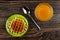 Biscuit waffle in saucer, spoon, transparent bowl with honey on table. Top view