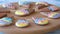 Biscuits with colorful glaze on wooden board.