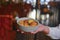 Biscuits with condensed milk in a white plate, closeup. Waiter serves nut cookies with condensed milk. Eating out