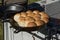 Biscuits cooking in an iron skillet