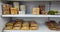 Biscuits are displayed on a shelf in a shop. Indonesian traditional cakes on display on a shelf