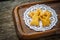 Biscuits on paper, stencil in wooden tray, wooden table