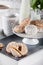 Biscuits on white tray with bottles of milk and lilak flowers