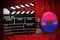 Bisexual flag with clapperboard and film reels on the red fabric, 3D rendering