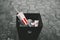 Bishkek, Kyrgyzstan - August 14 , 2021 :   Dirty thrown crushed  KFC branded paper bucket at garbage bin