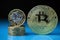 Bitcoin and British one pound coins placed together on the reflective surface with blurred background. Concept for cryptocurrency