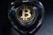 Bitcoin BTC crypto coin placed on the heart shaped crystal