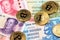 Bitcoin BTC cryptocurrency coins on China Yuan Renminbi and Zimbabwe hyperinflation Dollar currency banknotes close up image.