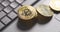 Bitcoin BTC cryptocurrency. Golden coins stack falling on laptop keyboard. Hand pushes pyramid