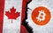 Bitcoin and Canada flag on a wall with a crack