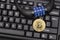 Bitcoin coin and combination lock on the keyboard. Cybersecurity. Investing in cryptocurrency