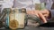 Bitcoin coin digital gold next to Expert trader hands counting income banknotes of euro cash from glass jar. Close up of