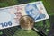 Bitcoin coin and magnifying glass with turkish lira banknotes on background