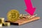 Bitcoin coin on a mousetrap background, cryptocurrency rate concept