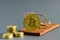 Bitcoin coin on a mousetrap background, cryptocurrency rate concept on the world market