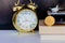 Bitcoin coins on book alarm clock old gold and model of passenger plane over white black background