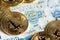 Bitcoin coins on Chilean banknote close up image. Bitcoin with Chilean pesos banknote.