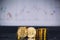 Bitcoin coins pile and two bit coins sitting in front with candle stick graph chart digital background