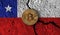 Bitcoin crypto currency coin with cracked Chile flag. Crypto restrictions