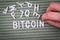 BITCOIN. Cryptocurrency, finance and profit concept. White letters of the alphabet with a woman& x27;s hand