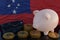 Bitcoin and cryptocurrency investing. Western Samoa flag in background. Piggy bank, the of saving concept. Mobile application for