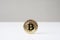 Bitcoin cryptocurrency physical coin standing upright on desk