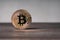 Bitcoin cryptocurrency physical copper coin on wooden desk