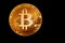 Bitcoin in the dark. Close up view on heap of golden bitcoins. Black background with copyspace