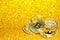 Bitcoin on defocused gold glitter background.