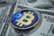 Bitcoin on dollars close up