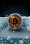 Bitcoin is freezing. Frozen Bitcoin, shiny gold bitcoin covered in ice during the cold crypto winter