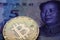 Bitcoin Gold Coin on Chinese Yuan banknote