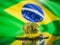 Bitcoin gold coin and defocused flag of Brazil background. Virtual cryptocurrency concept.