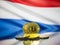 Bitcoin gold coin and defocused flag of Netherlands background. Virtual cryptocurrency concept.