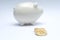 Bitcoin gold coin and defocused piggy bank, moneybox. Virtual cryptocurrency