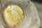 Bitcoin gold coin frozen in half in a piece of ice on a gray background. The freezing of financial assets. The fall of