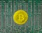 Bitcoin gold coin on PCB background