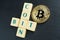 Bitcoin gold coin with text made out of letter tiles