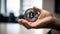 Bitcoin Held in Hand on Blurred Financial Background