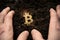 Bitcoin hold concept. Cryptocurrency stored in the ground - saving symbol. A man digs up hidden bitcoins